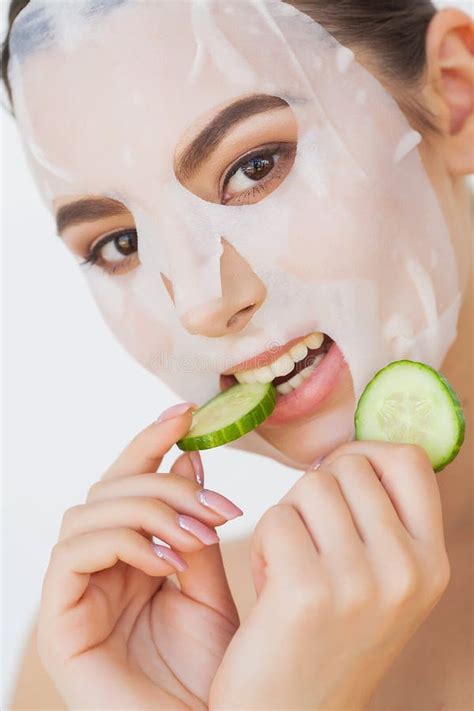 Beautiful Young Woman Is Getting Facial Clay Mask At Spa Lying With