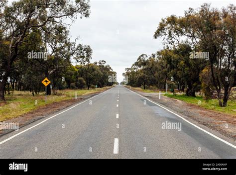 Very straight road in rural Victoria in Australia, with a sign warning ...