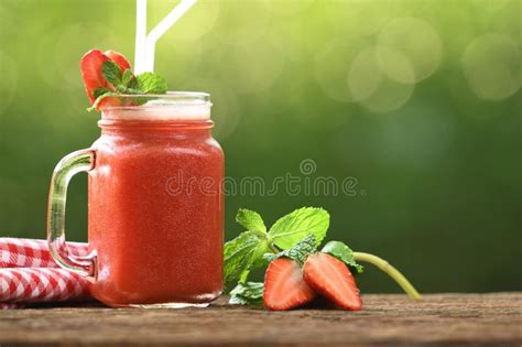 Smoothie De La Fresa En Vidrio Con Las Bayas Cortadas En Fondo De