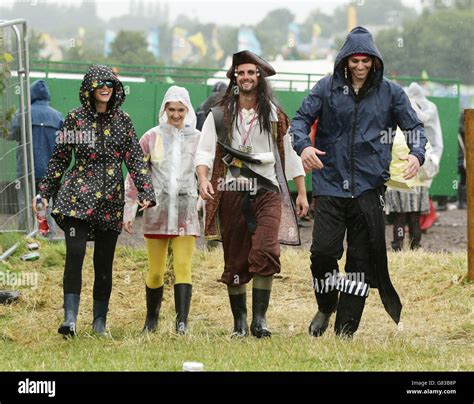 Festival Goers In The Rain At The Glastonbury Festival At Worthy Farm