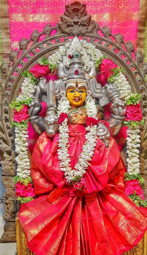 An Idol Is Displayed In Front Of A Wall With Flowers And Other