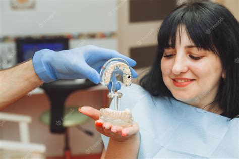 Premium Photo A Male Orthodontist Dentist Shows An Artificial Plastic