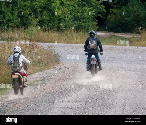 Two Motor Cyclists Bikers Riding Their Off Road Motorbikes Along A