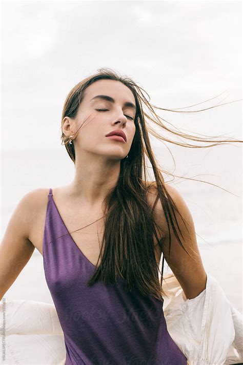 Beautiful Sensual Caucasian Woman Posing With Closed Eyes On Windy Beach Del Colaborador De