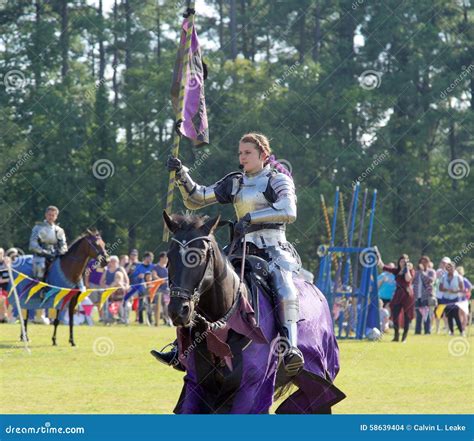 A Female Knight Carries A Flag On A Horse At The Mid South Renaissance