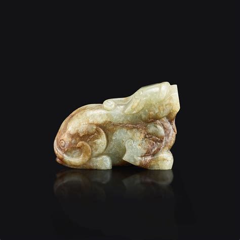 A celadon and russet jade figure of a mythical beast Ming dynasty 明