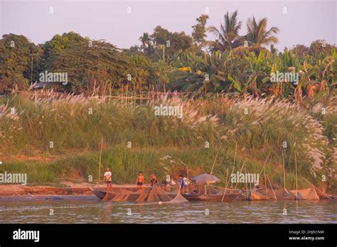 Cambodian Fishermen Hauling In Their Fishing Nets On The Bank Of The