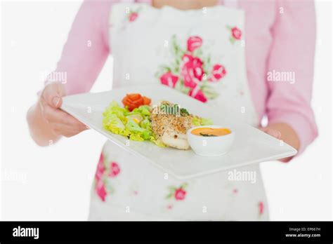 Woman In Apron Holding Plate Of Healthy Meal Stock Photo Alamy