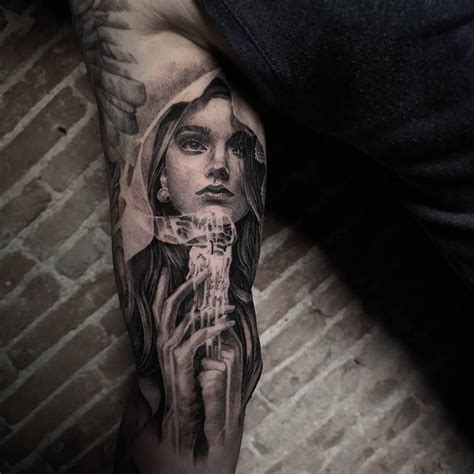 Virgin Mary Portrait Tattoo In Black And Grey On The Sleeve Made