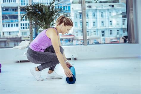 Concentrated Mature Woman Rolling Up Mat Board Stock Photo Image Of