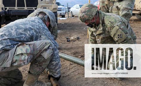 Soldiers With 2nd Stryker Brigade Combat Team 4th Infantry Division Assemble A Tow Bar To Tow A