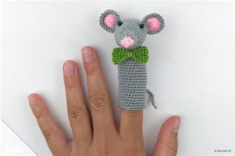 A Crocheted Mouse With A Green Bow Tie On It S Head And Hand