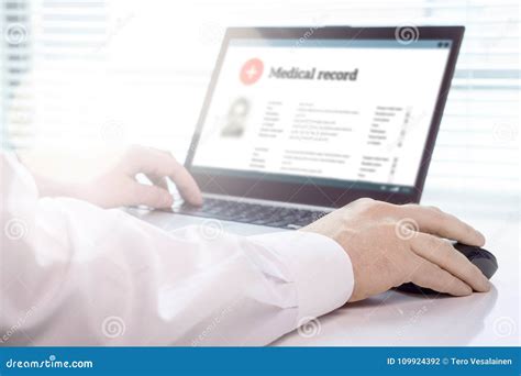 Doctor Using Laptop And Electronic Medical Record Emr System Stock