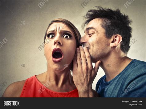 Man Whispering In Womans Ear