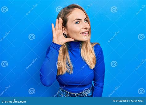 Young Caucasian Woman Wearing Casual Clothes Smiling With Hand Over Ear