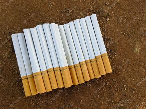 Premium Photo A Stack Of Cigarettes On The Ground