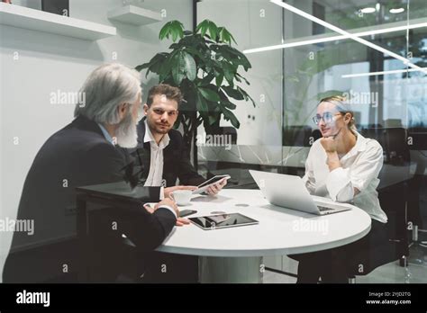 Office Full Of Caucasian Business People Of Different Ages Working At