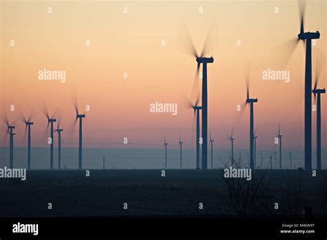 Wind Turbines Farm Field At Sunrise Stock Photo Alamy