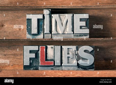 Time Flies Phrase Made From Metallic Letterpress Type On Wooden Tray