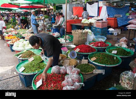 Man Selling Chillies Peppers On Khlong Toei Wet Market Bangkok