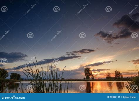 Sunset Over Calm Lake Sky Reflection In Water Stock Image Image Of