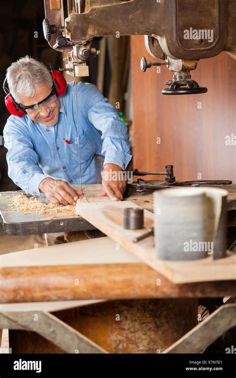 Carpenter Using Bandsaw To Cut Wood Stock Photo Alamy