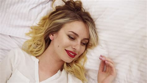 Free Stock Video Beautiful Blonde Woman With Natural Make Up And Red Lipstick Lying On The Bed