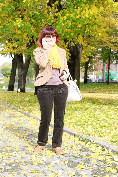 Full Length Mature Woman Talking On The Phone Stock Image Image Of Leaves Brown 65220157