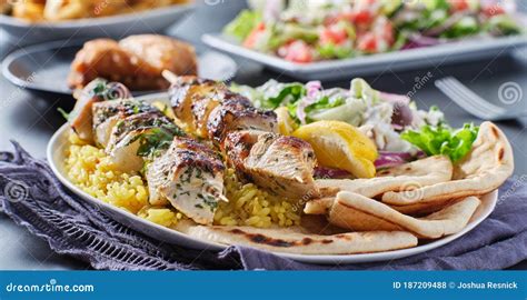 Greek Chicken Souvlaki Platter With Pita Bread Salad And Rice Stock