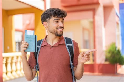 Premium Photo Young Arabian Handsome Man Holding A Passport At