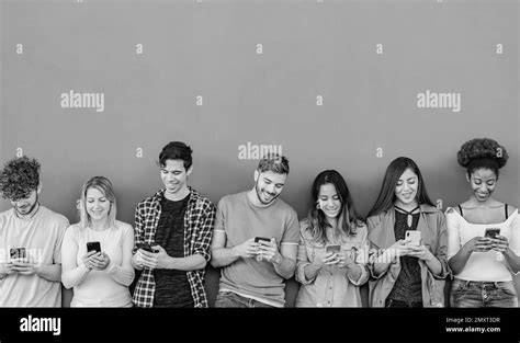 Young Multiracial Group Of Friends Using Mobile Smartphone Outdoor