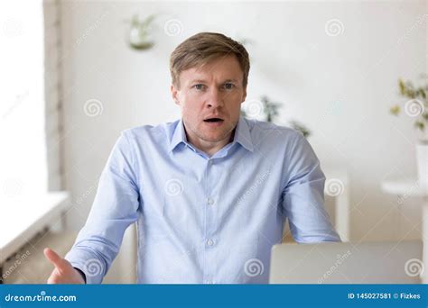 Bewildered Businessman Throwing Up His Hands Royalty Free Stock Image