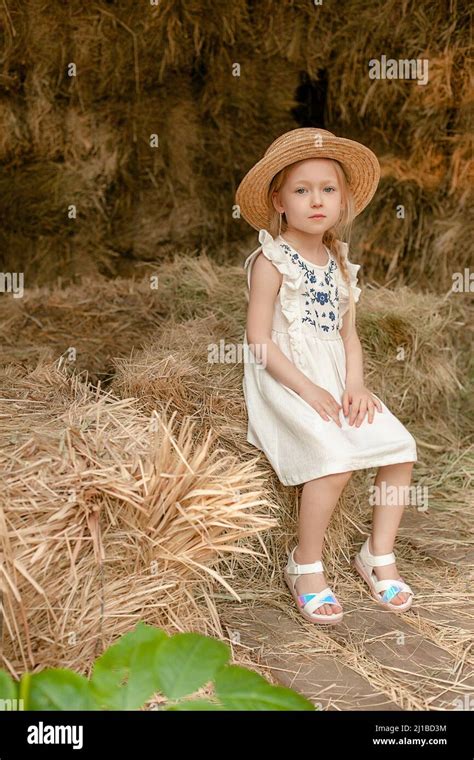 Dreamy Blonde Preteen Girl Resting On Hayloft In Summer Stock Photo Alamy