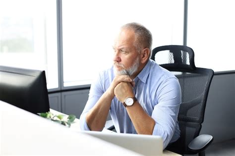 Premium Photo Focused Mature Businessman Deep In Thought While