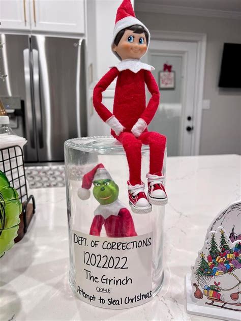 An Elf Is Sitting On Top Of A Glass Jar With The Name Of His Character