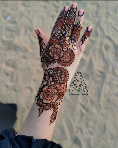 A Woman S Hand With Henna Tattoos On It