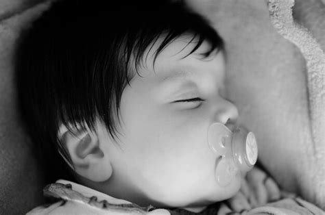 Premium Photo Close Up Of Cute Baby With Pacifier In Mouth While