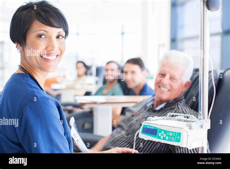 Portrait Of Smiling Doctor Assisting Patient Undergoing Medical