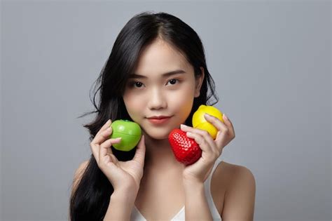 Premium Photo A Woman Holding A Bunch Of Fruit With A Red Heart On