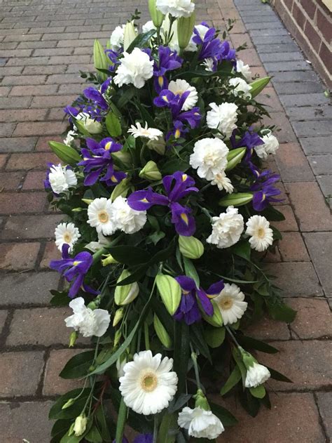 White Lillies Gerbera S Carnations With Blue Iris Casket Spray