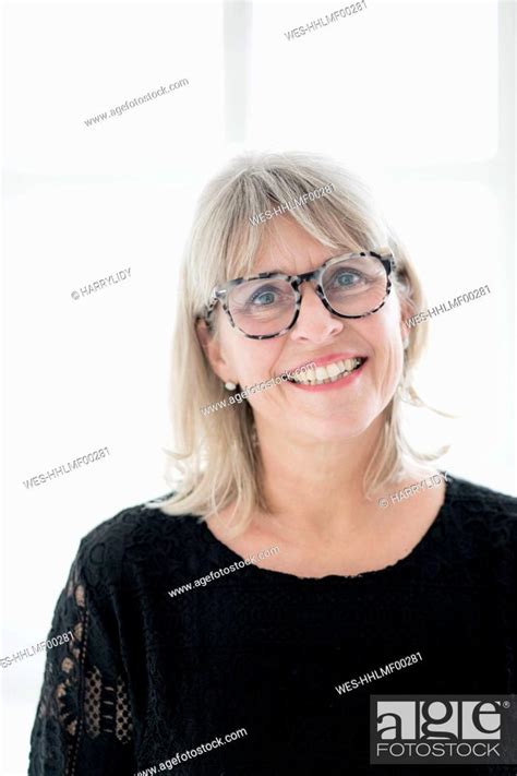 Portrait Of Smiling Mature Woman Wearing Glasses Stock Photo Picture