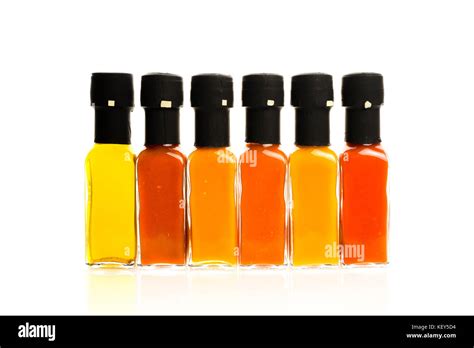 Set Of Hot Chili Sauce Glass Bottles On White Background Different Color Home Made Hot Sauce In