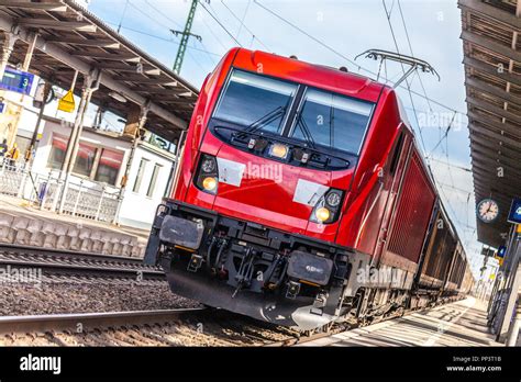 German Freight Train Passes A Train Station Stock Photo Alamy