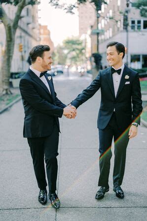 Grooms In Coordinating Formal Black And White Tuxedos White Boutonnieres