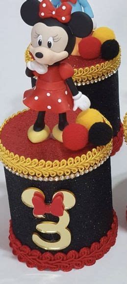 Two Mickey Mouse Figurines Sitting On Top Of Each Other