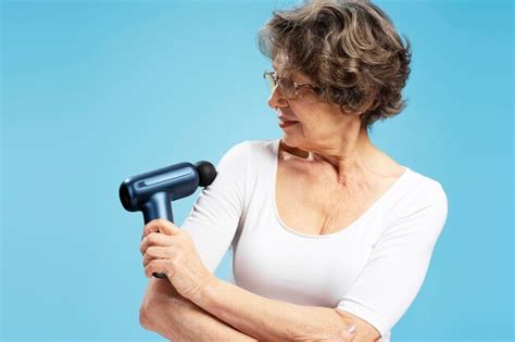 Premium Photo Attractive Gray Haired Mature Woman Holding Massager