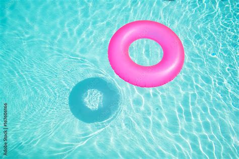 Bright Pink Float In Blue Swimming Pool Ring Floating In A Refreshing