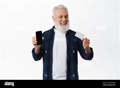 Smiling Mature Man Showing Smartphone Blank Screen Looking Satisfied