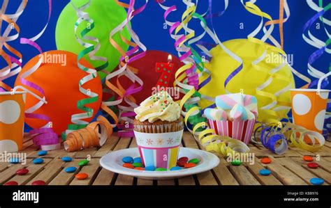 birthday cupcake  candles burning  rustic wooden table