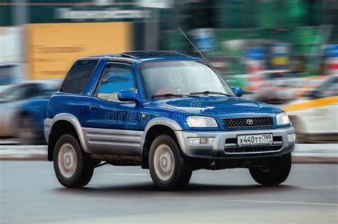 Toyota RAV4 Car Is Driving In The Cityscape Front Side View Of Old